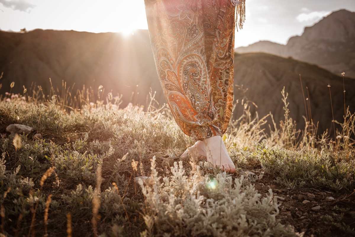 Beautiful hippie young beautiful woman with red hair dressed in boho style. Beautiful movie series at sunset. The idea of freedom